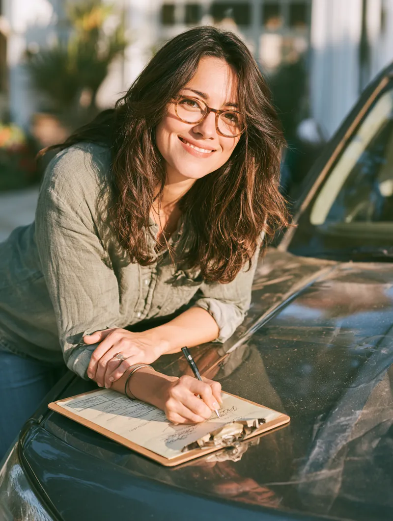 Signing an auto repair loan application on a clipboard